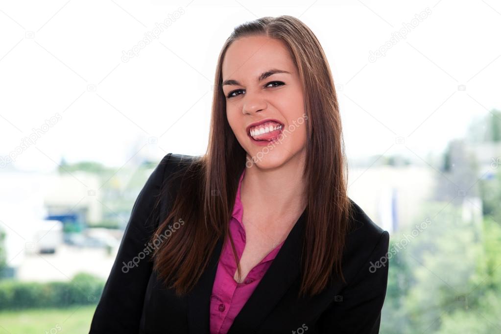 Businesswoman showing tongue