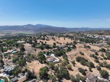 Aerial view of dry valley and land with houses and barn in Escondido, San Diego, California
