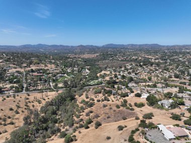 Aerial view of dry valley and land with houses and barn in Escondido, San Diego, California