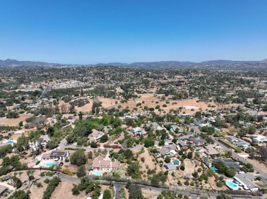 Aerial view of dry valley and land with houses and barn in Escondido, San Diego, California