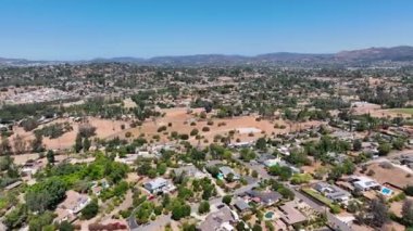 Aerial view of dry valley and land with houses and barn in Escondido, San Diego, California