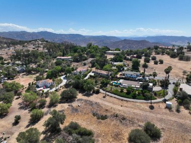 Aerial view of dry valley and land with houses and barn in Escondido, San Diego, California