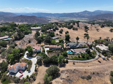 Aerial view of dry valley and land with houses and barn in Escondido, San Diego, California