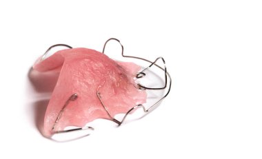 Pink orthodontic teeth retainer isolated on white background.