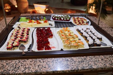 Various desserts in candy bar food buffet during hotel brunch. Self service in hotel restaurant