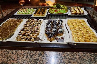 Various desserts in candy bar food buffet during hotel brunch. Self service in hotel restaurant