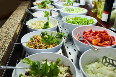 Restaurant with fresh and organic salads. Self-service food in a mall.    Salad meals on counter top at buffet catering service 