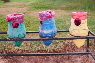Clay pots of blue, yellow and green colors for Paper, Plastic, Metal, Glass. Garbage sorting in a hotel of Egypt.
