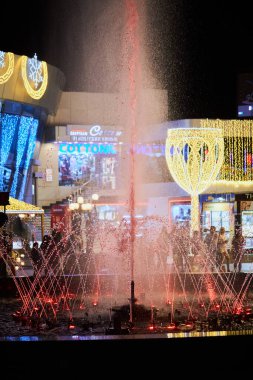 Sharm El Sheikh, Egypt - November 20, 2021: Night colorful  light-musical fountain at modern building of Culturama cinema in popular shopping and entertainment complex of Soho Square at the evening