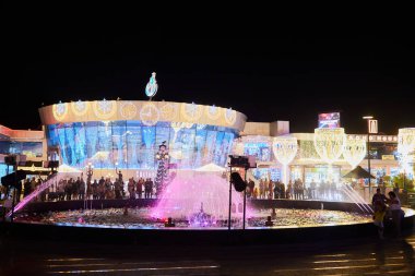 Sharm El Sheikh, Egypt - November 20, 2021: Night colorful  light-musical fountain at modern building of Culturama cinema in popular shopping and entertainment complex of Soho Square at the evening