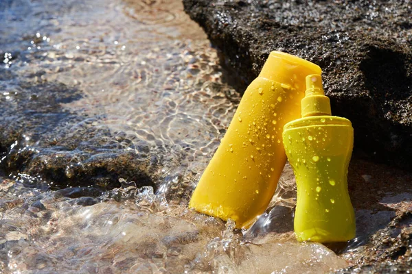 Yellow Sunscreen Cream Bottles Skin Protection Stone Sea Summer Recreation — стоковое фото