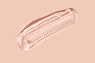 Bej bir arka planda sıvı şeffaf jel lekesi (ya da antibakteriyel ya da serum jeli). Makyaj ve kozmetik dokusu, cilt ürünü