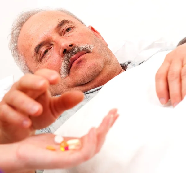 Sick man taking pills — Stock Photo, Image