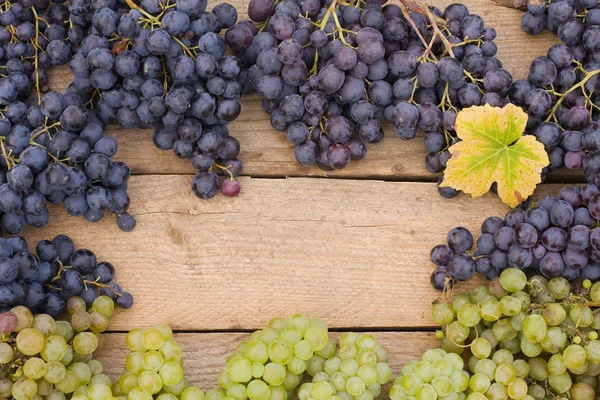 Grape on a wooden table — Stock Photo, Image