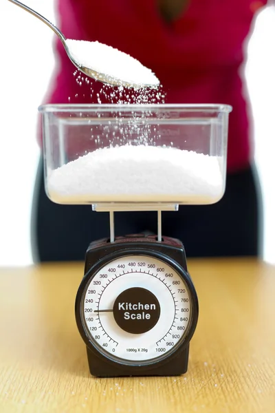 Sugar in kitchen scale — Stock Photo, Image