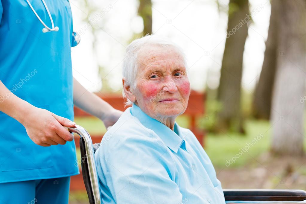 Walking with an Elderly Lady in Wheelchair