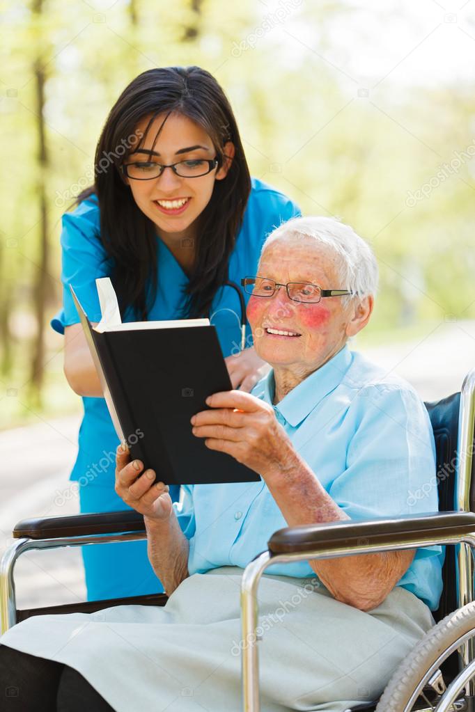 Elderly Lady in Wheelchair Reading