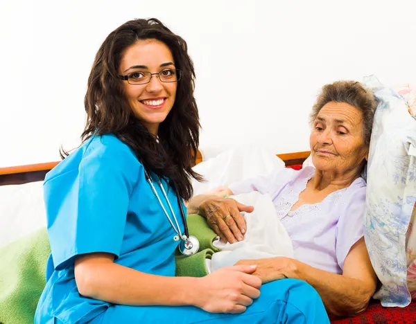 Krankenschwester kümmert sich um älteren Patienten — Stockfoto