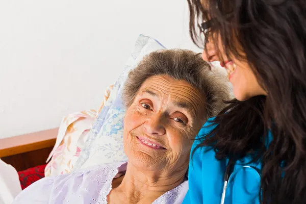 Kind nurse with elderly lady — Stock Photo, Image