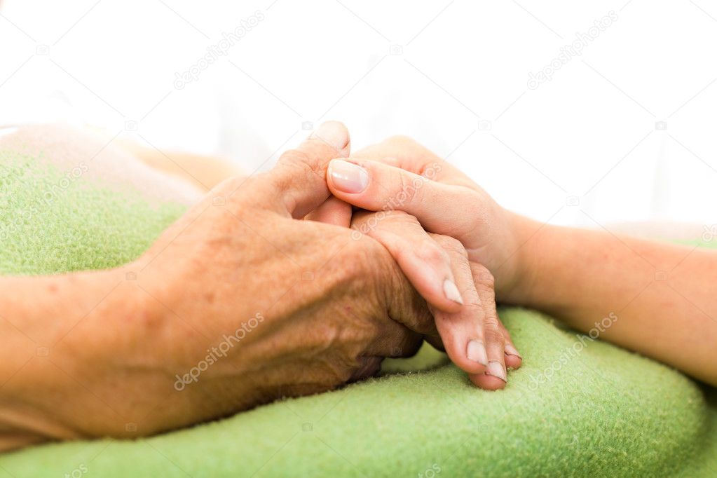 Nurse holding woman hand