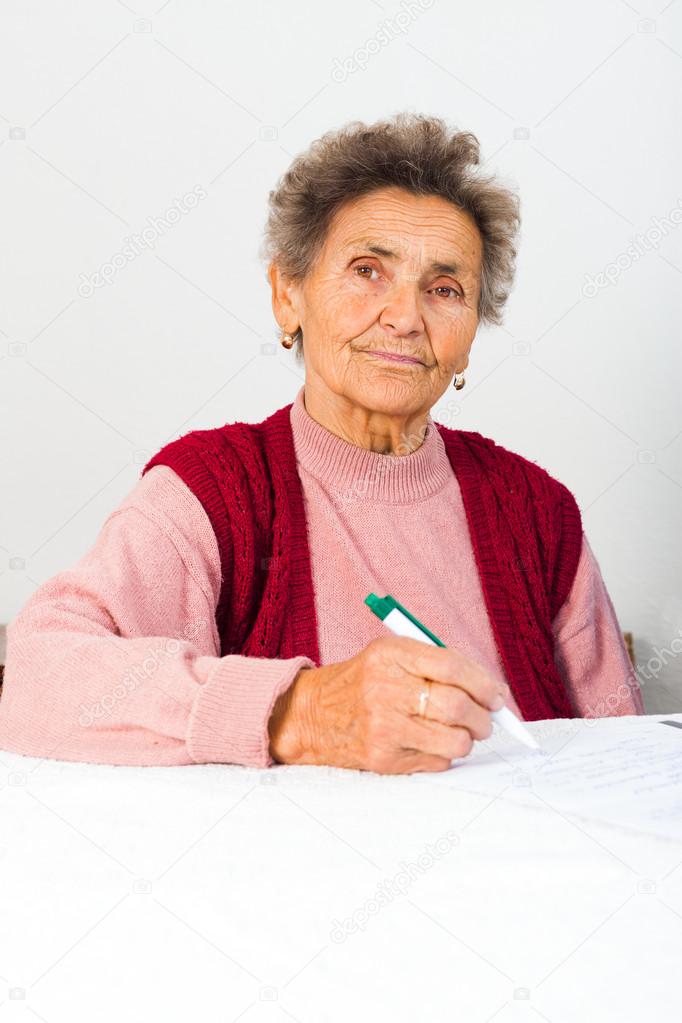 Elderly lady signing contract