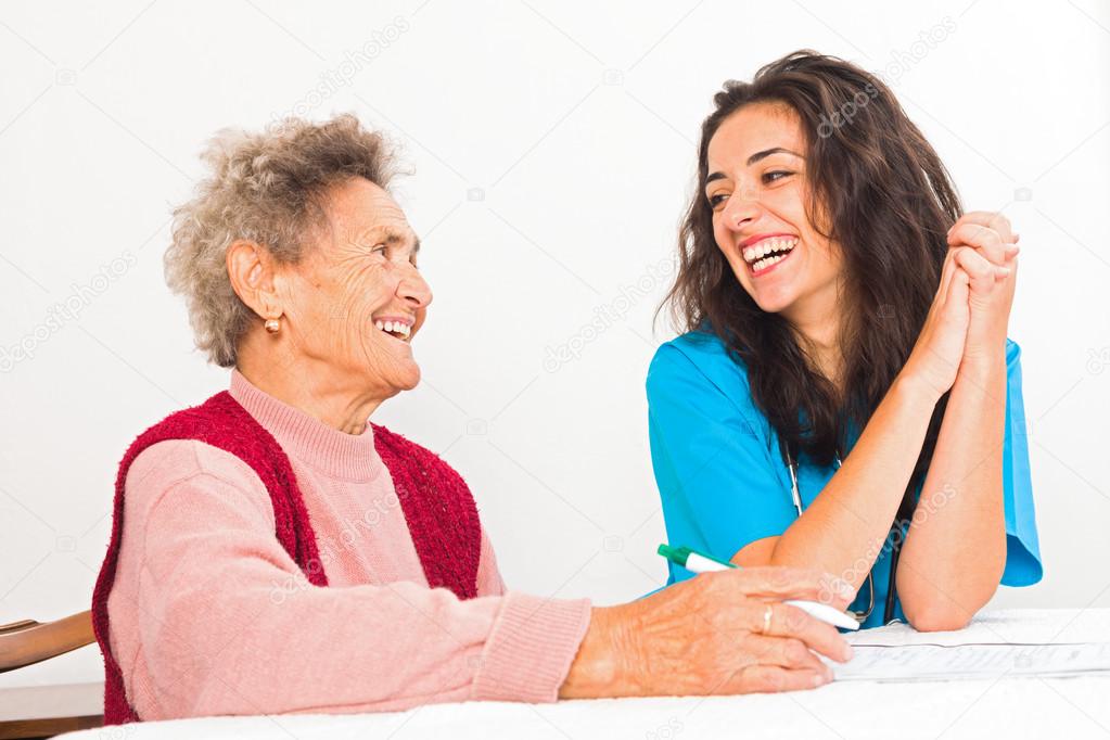Laughing elderly lady and nurse