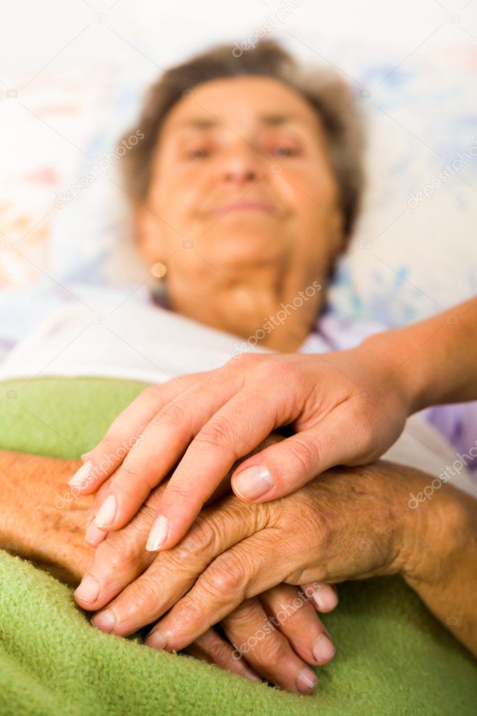 Caring nurse holding hands