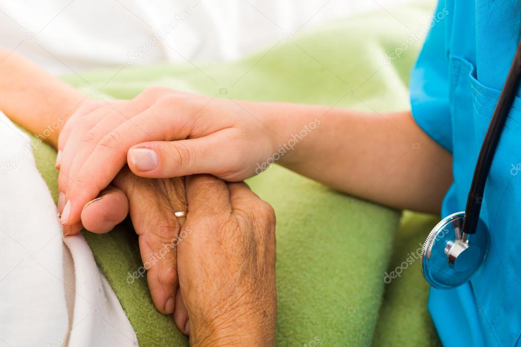 Nurse helping elderly lady