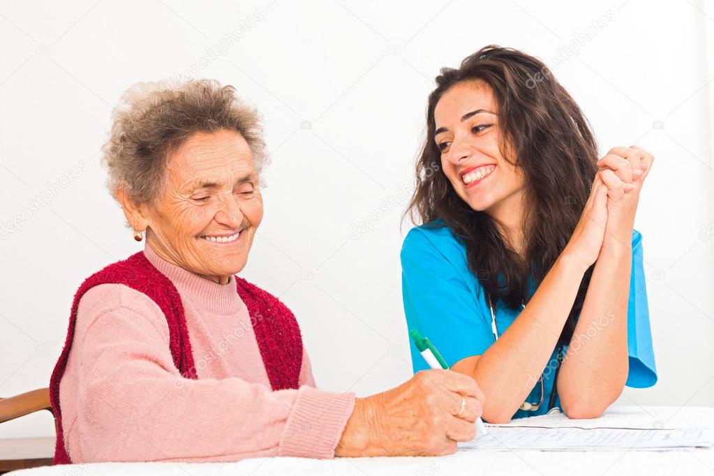 Urse helping elderly woman