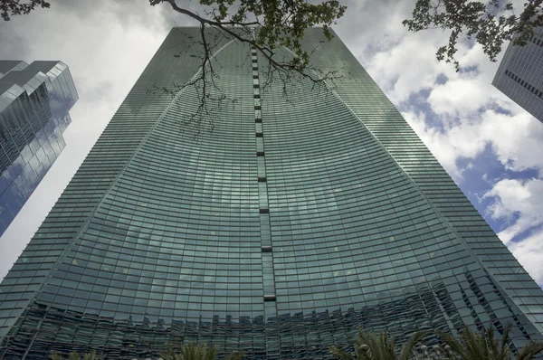 Modern office building against clouds