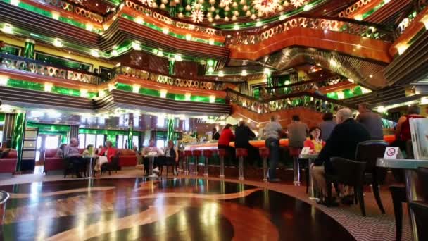 Passengers of Costa Concordia cruise ship relaxing at the elegant lobby bar — Stock Video