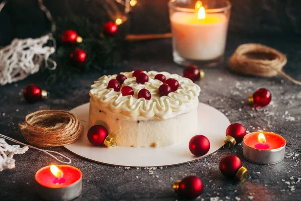 Christmas cake. Delicious cake with winter decor. Lingonberry cake on the table