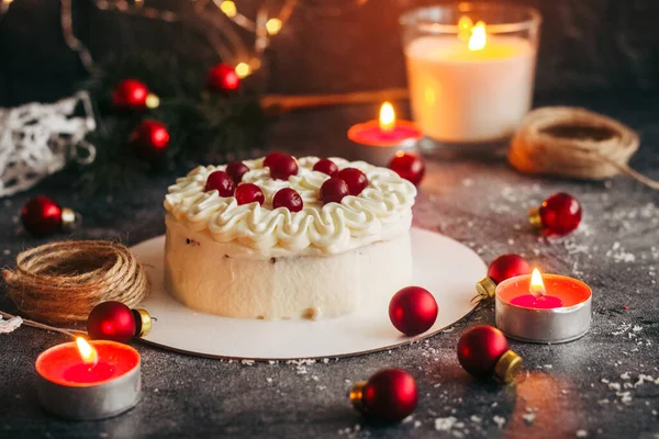 Christmas cake. Delicious cake with winter decor. Lingonberry cake on the table