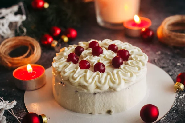 Christmas cake. Delicious cake with winter decor. Lingonberry cake on the table