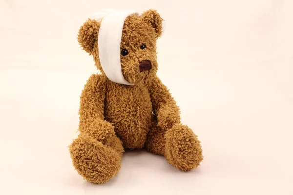 Bear toy with toothache bandage Royalty Free Stock Photos