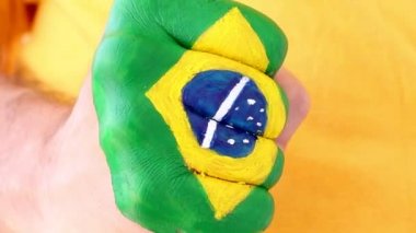 Brezilyalı futbol futbol fan kazanan bir jest, yumruğunu Brezilya bayrağı yapıyor