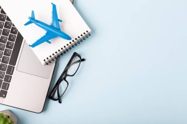 View home desk with airplane model and notebook . High quality photo