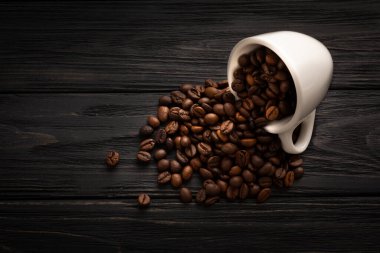 Coffee with beautiful foam with coffee beans on black boards. High quality photo
