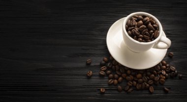 Coffee with beautiful foam with coffee beans on black boards. High quality photo