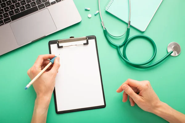 Doctor work at the table with a stethoscope and a notebook with a place for your text. High quality photo