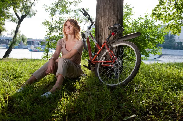 Girl sits with a bicycle