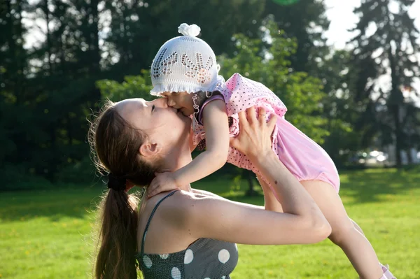 Young mother kiss her daughter — Stock Photo, Image