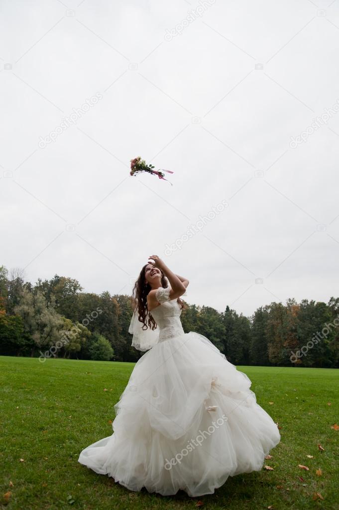 Bride tossing bouquet Stock Photo by ©maxsaf 13961111