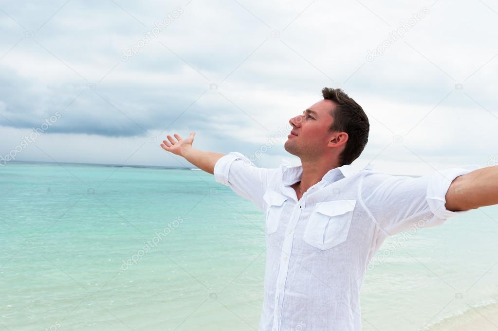 Man looking into the distance with his hands up