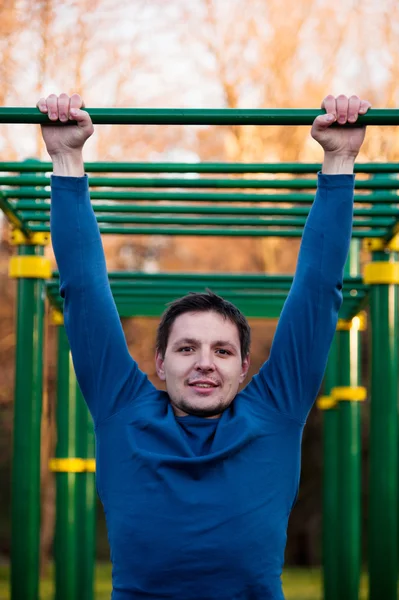 Yatay çubuğu pull-up yapan atletik erkek — Stok fotoğraf
