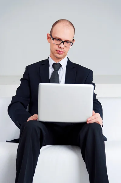 Бизнесмен сидит с ноутбуком — стоковое фото