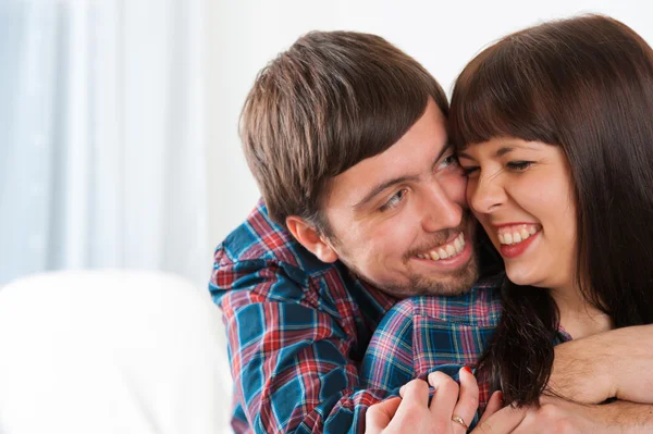 Porträt eines jungen lächelnden verliebten Paares. Mann umarmt seine Freundin — Stockfoto