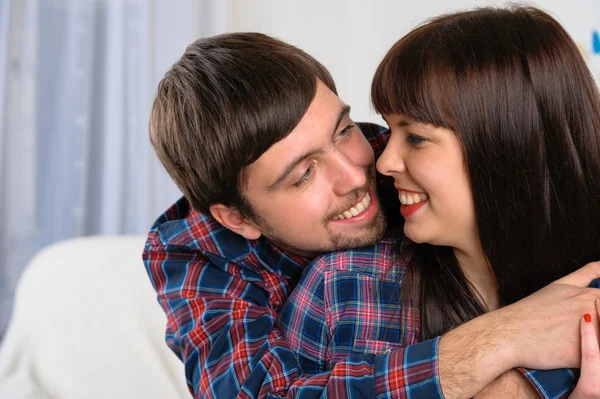 Portrait of happy young couple smiling to each other — Stock Photo, Image