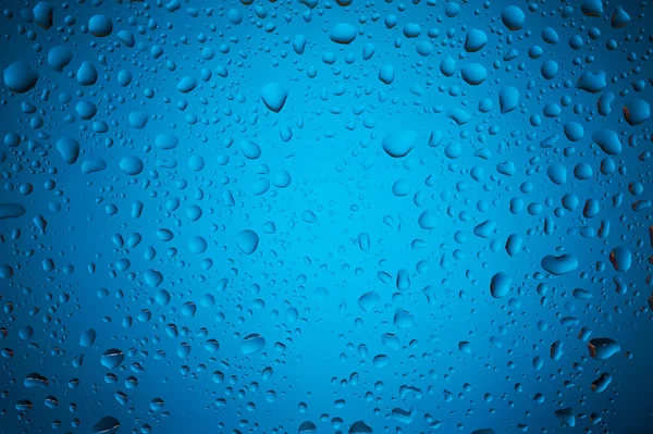 Blue water drops on glass — Stock Photo, Image