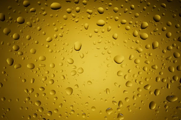 Gold yellow water drops on glass — Stock Photo, Image